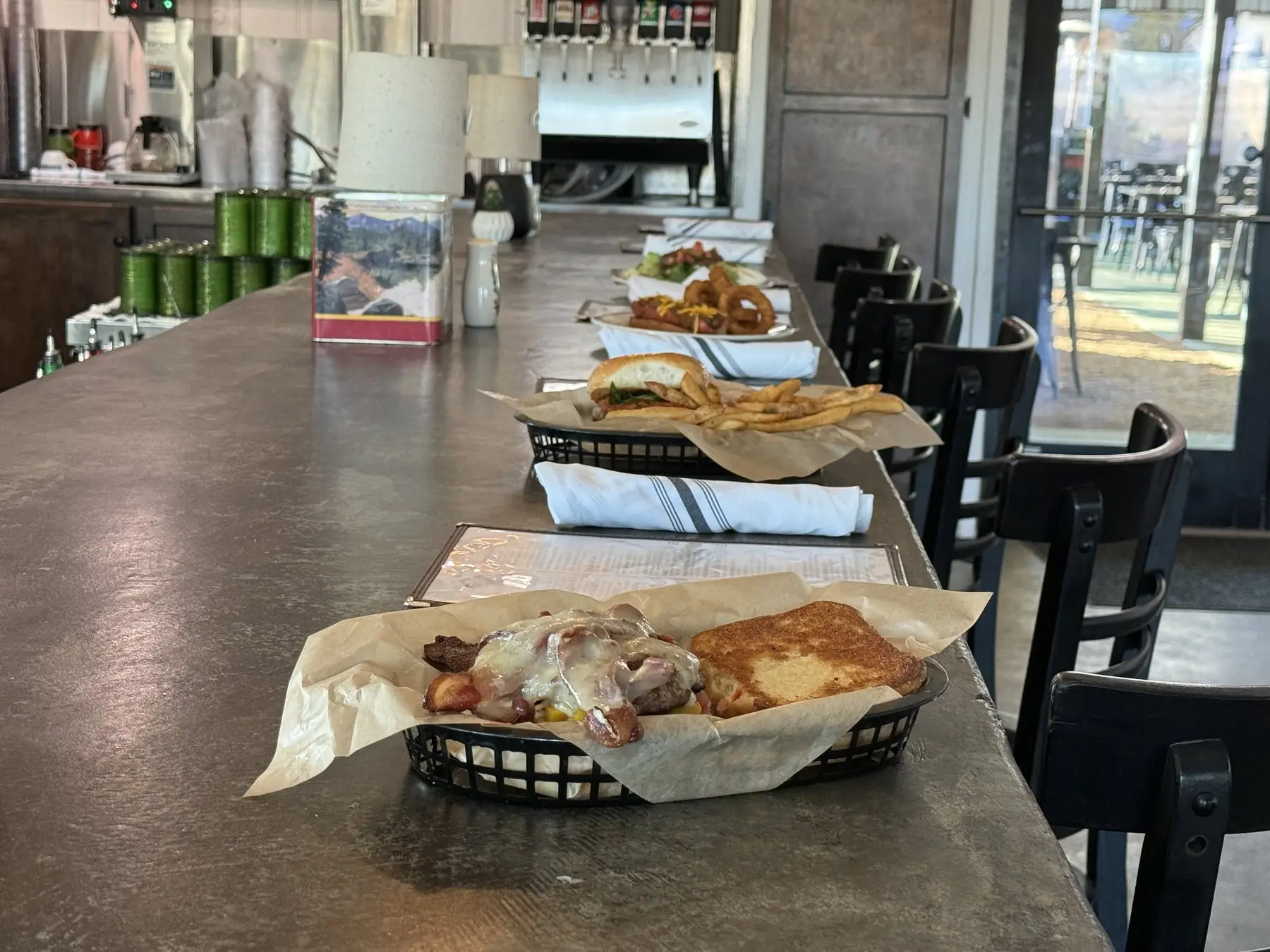 JD's burgers and sides lined up across the restaurant bar